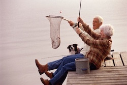 Elderly couple fishing on dock
