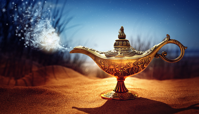 Magic lamp in the desert from the story of Aladdin with Genie appearing in blue smoke concept for wishing, luck and magic