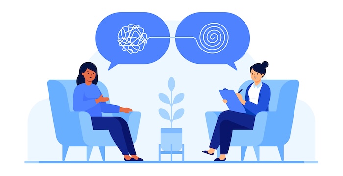 Female psychologist and patient talking in therapy session.